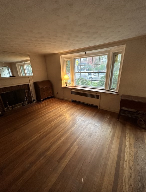 72 Redlands Road Boston, MA 02132 - Photo 9 of 19 an empty room with wooden floor and windows