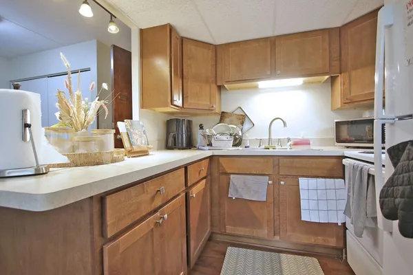 a kitchen with stainless steel appliances a sink stove and cabinets