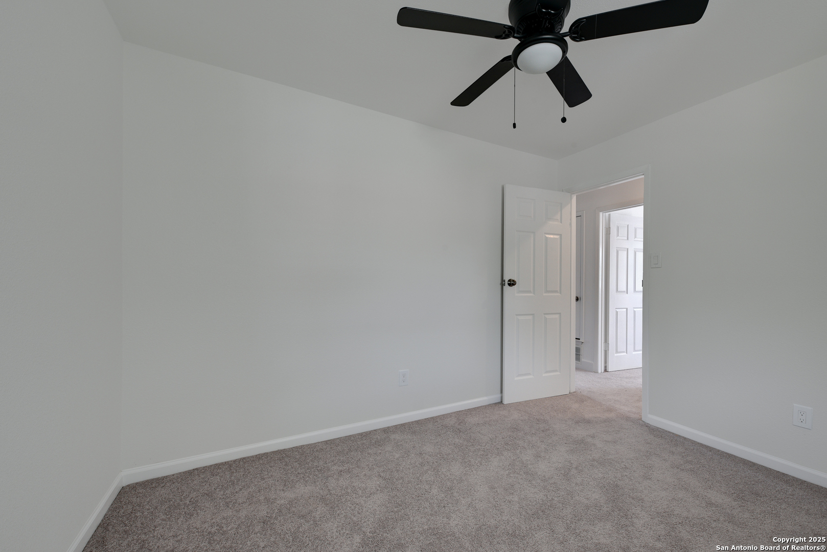 8903 Ridge Sky Street San Antonio, TX 78250 - Photo 16 of 20 a view of a room with a ceiling fan