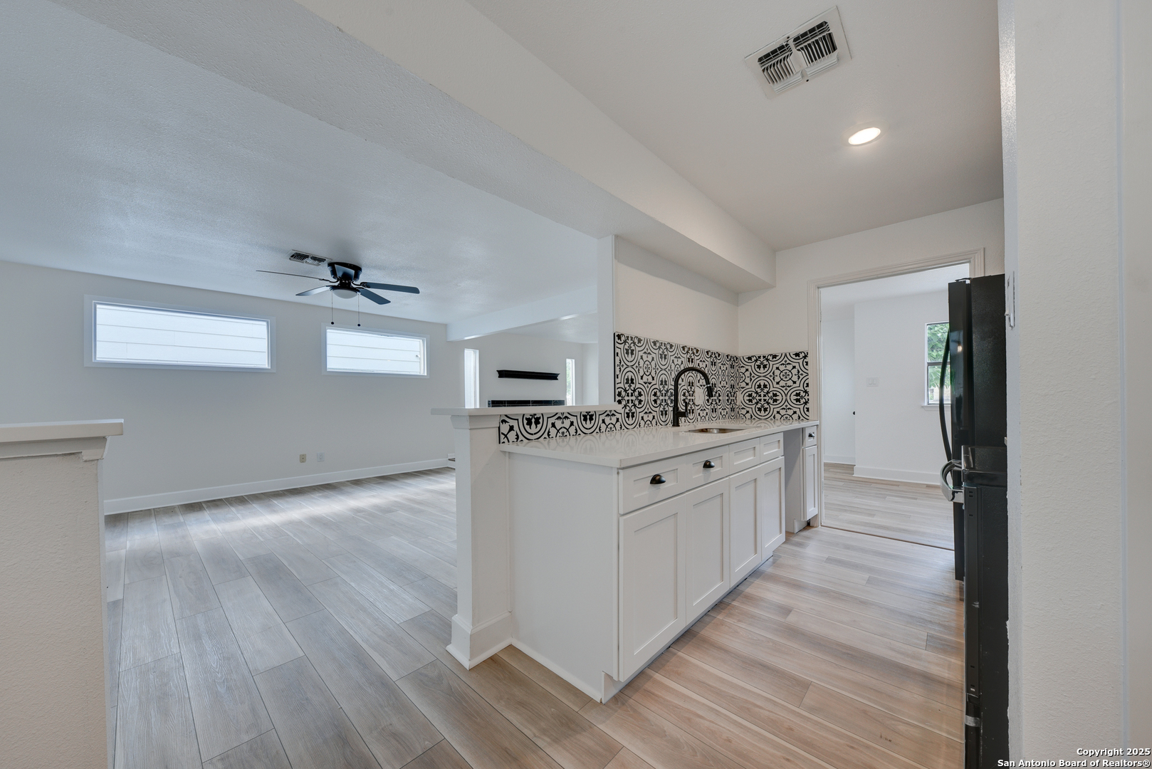 8903 Ridge Sky Street San Antonio, TX 78250 - Photo 4 of 20 a large kitchen with a wooden floor and stainless steel appliances