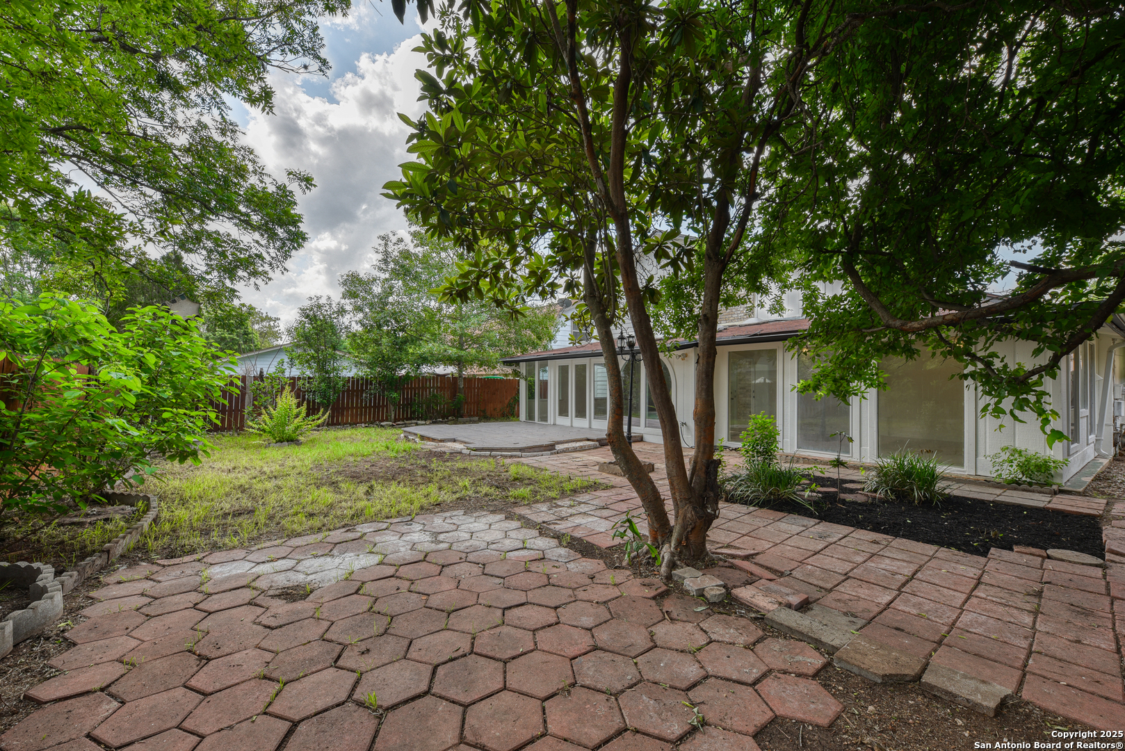 8903 Ridge Sky Street San Antonio, TX 78250 - Photo 7 of 7 a front view of a house with a yard and potted plants