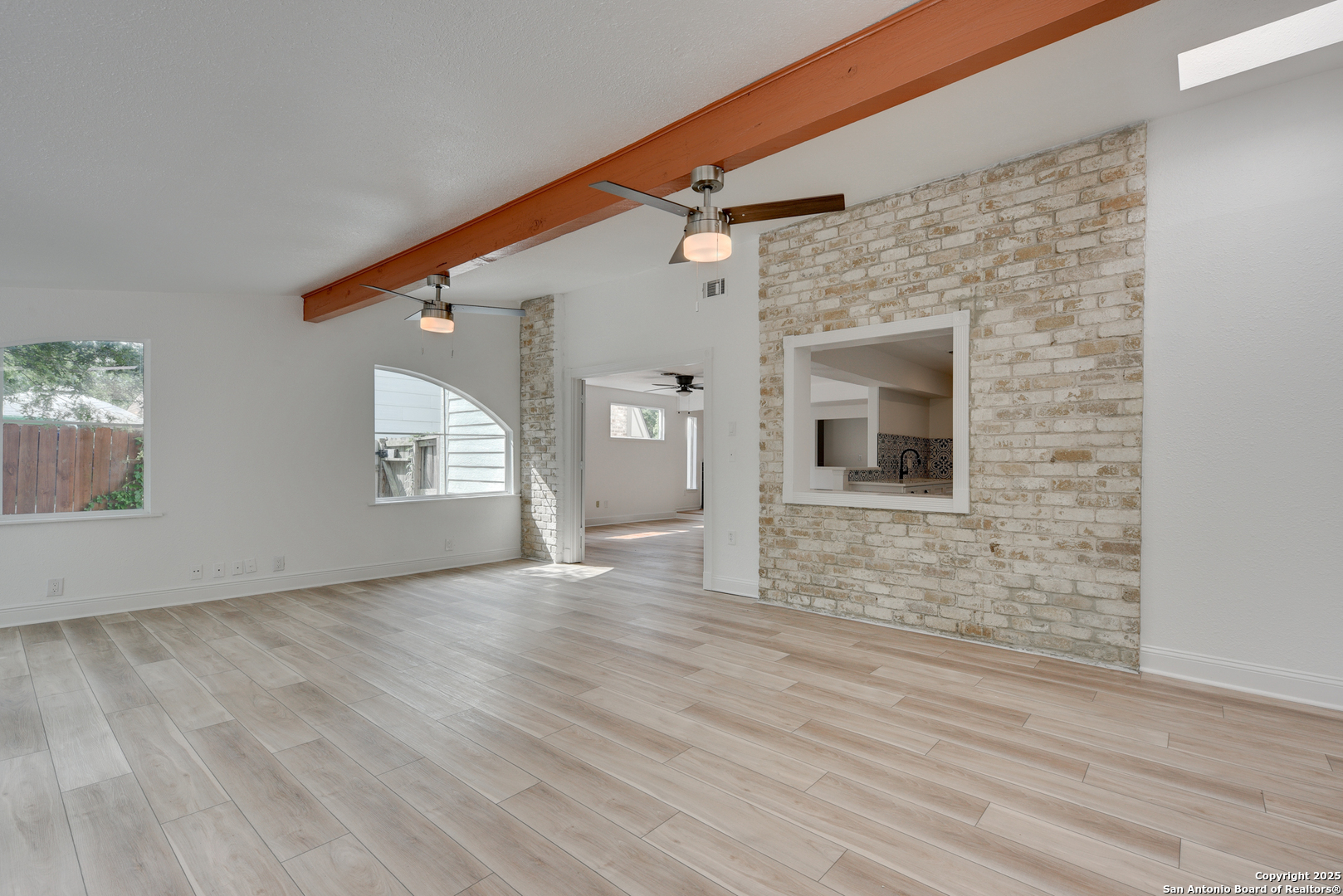 8903 Ridge Sky Street San Antonio, TX 78250 - Photo 8 of 20 en empty room with wooden floor and windows