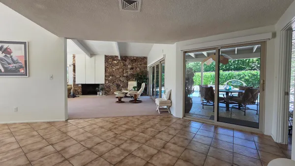 a view of a livingroom with furniture and a floor to ceiling window
