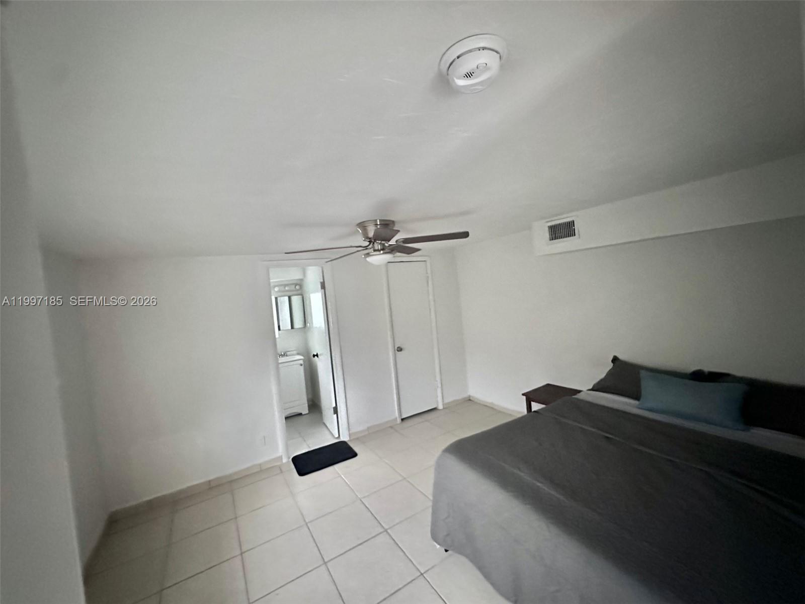 1375 Northwest 84th Terrace, Unit A Miami, FL 33147 - Photo 7 of 11 a living room with furniture and a ceiling fan