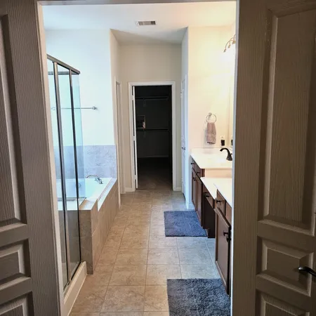 a bathroom with a sink a mirror and a bathtub