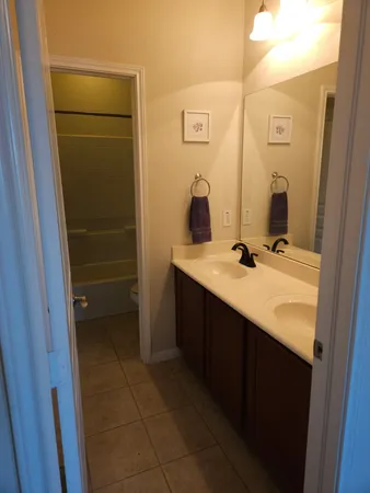 a bathroom with a double vanity sink a and mirror