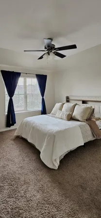 a bedroom with a bed and a night stand
