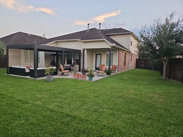 a front view of a house with a garden and patio