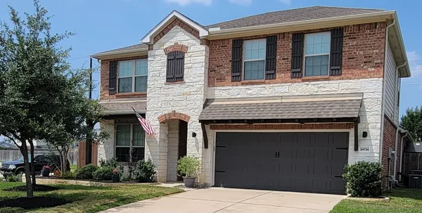 a front view of a house with yard