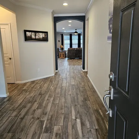 a view of a hallway with wooden floor