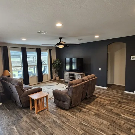 a living room with furniture and a flat screen tv