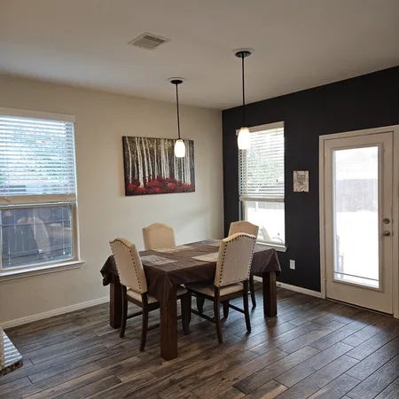 a view of a dining room with furniture window and wooden floor
