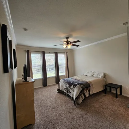 a spacious bedroom with a bed and large mirror