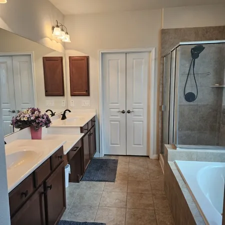 a bathroom with a tub sink and mirror