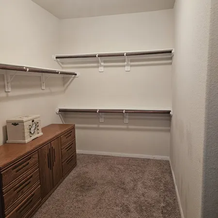 a view of storage and utility room with racks on the wall
