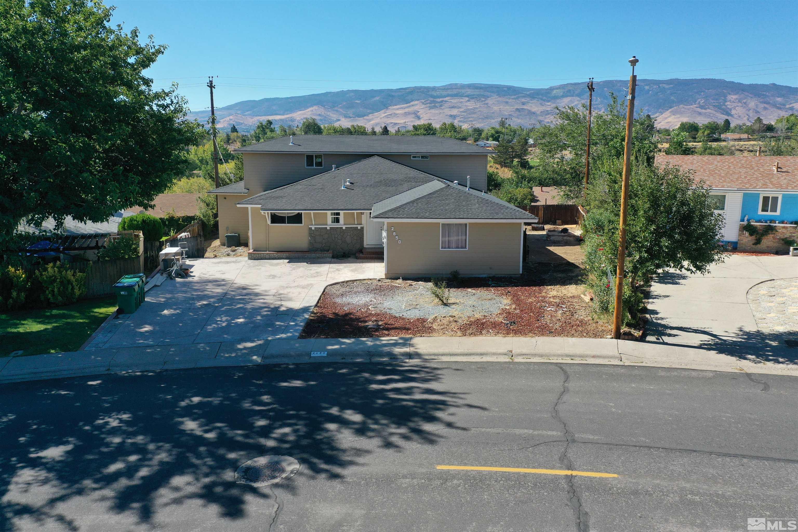 2650 Apollo Way Reno, NV 89503 - Photo 1 of 36 a front view of a house with a yard