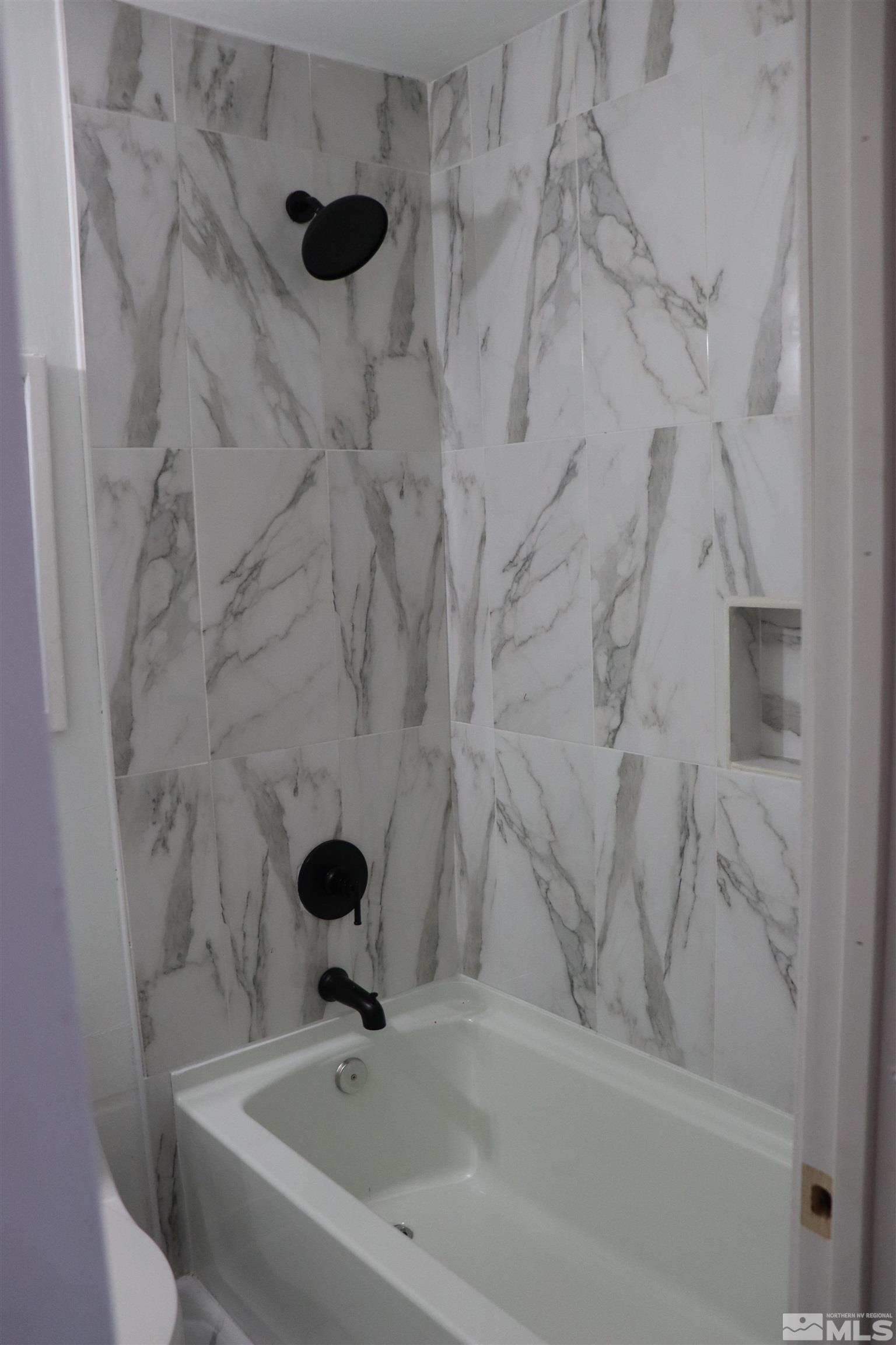2650 Apollo Way Reno, NV 89503 - Photo 11 of 36 a bathroom with a sink and a shower