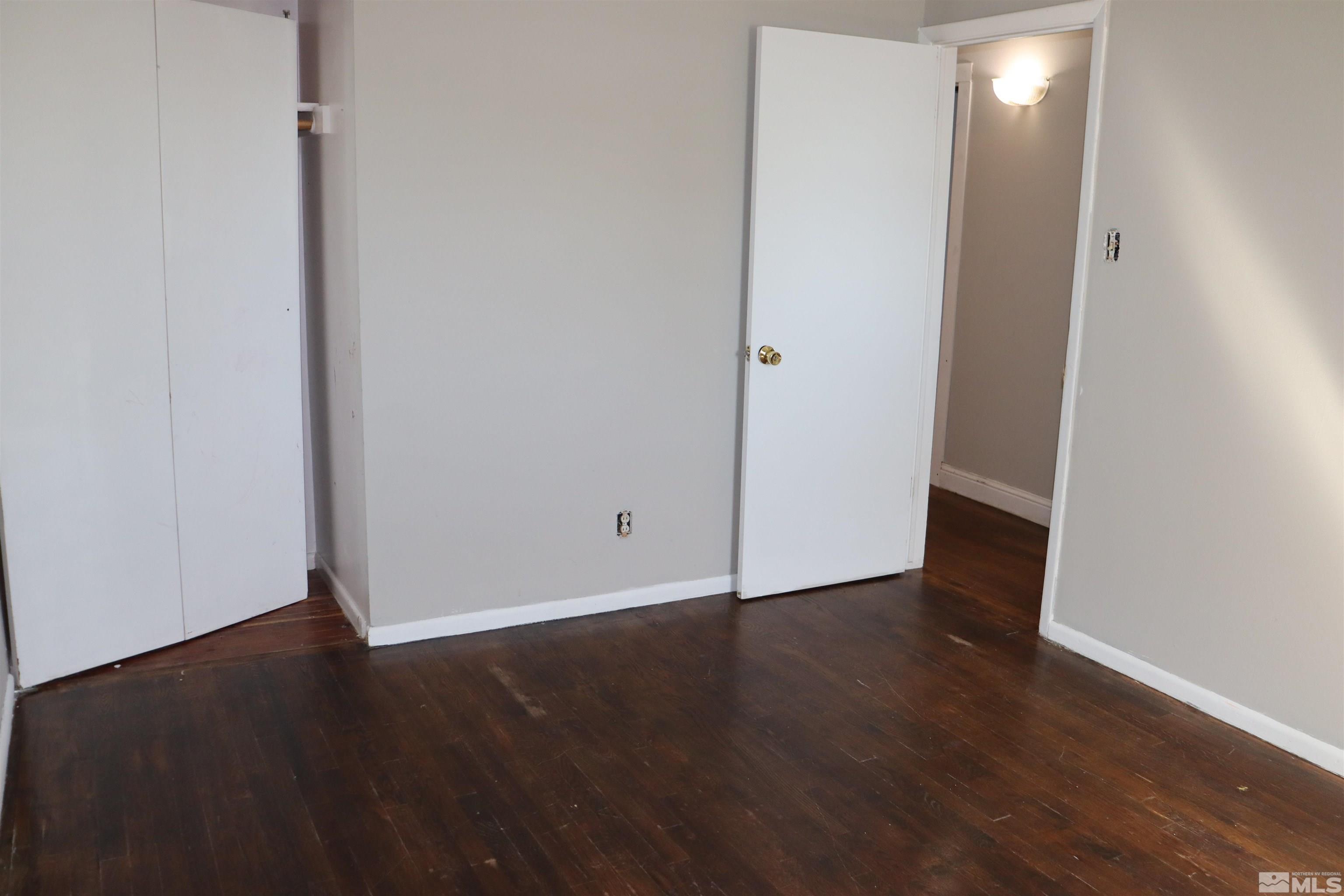 2650 Apollo Way Reno, NV 89503 - Photo 12 of 36 an empty room with wooden floor and windows
