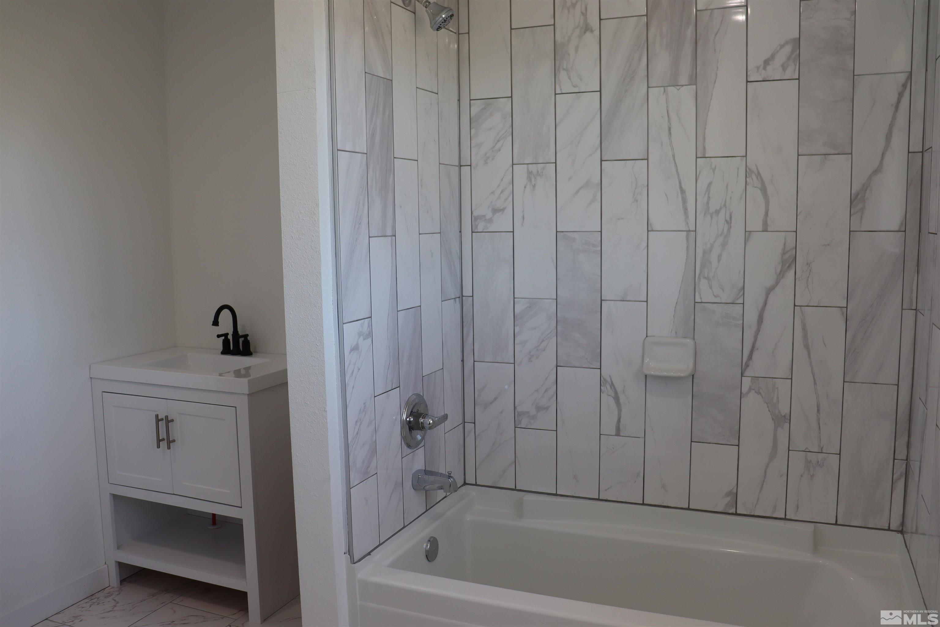 2650 Apollo Way Reno, NV 89503 - Photo 15 of 36 a bathroom with a bathtub and a shower