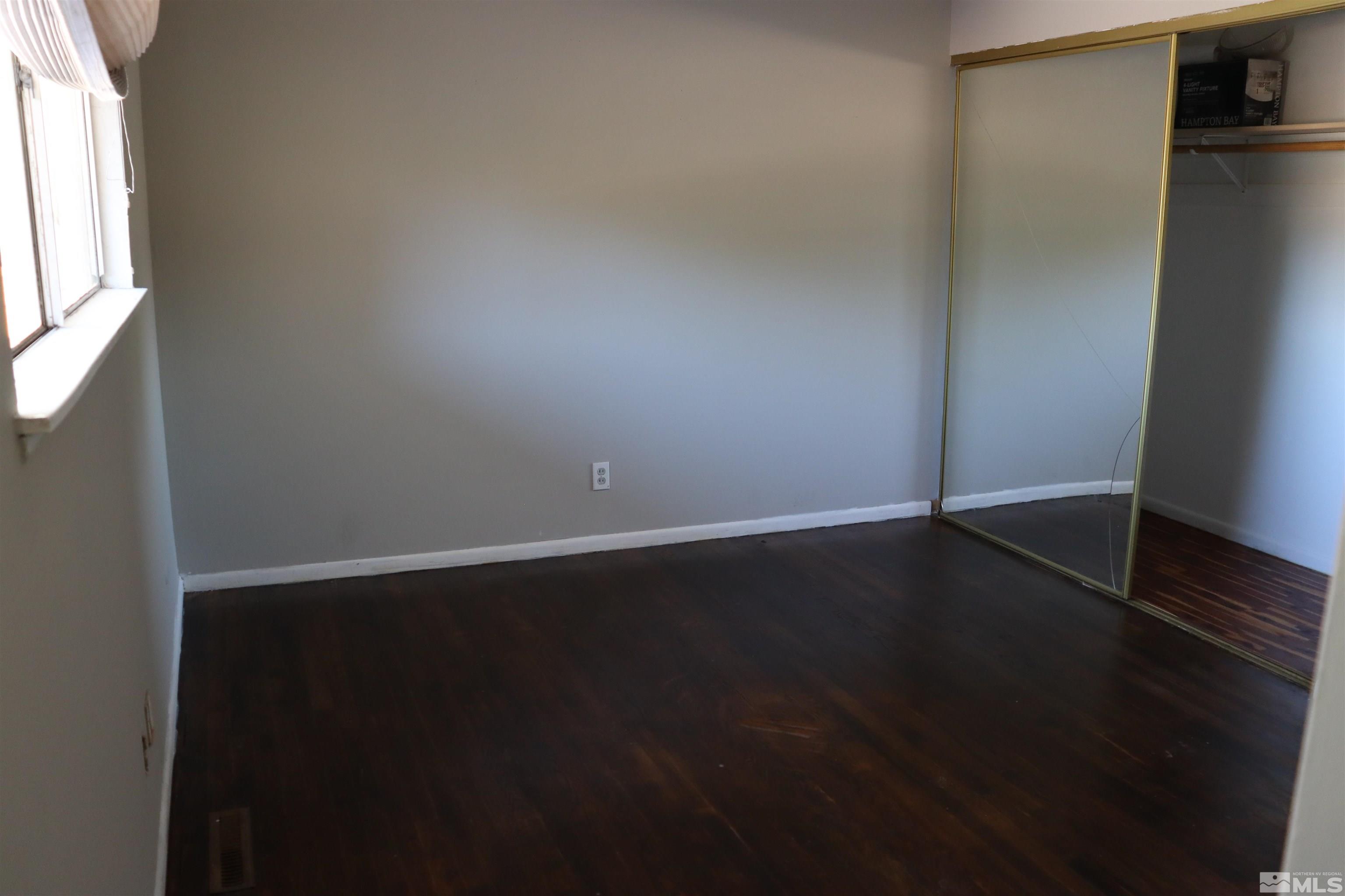 2650 Apollo Way Reno, NV 89503 - Photo 17 of 36 a view of an empty room with wooden floor and a window
