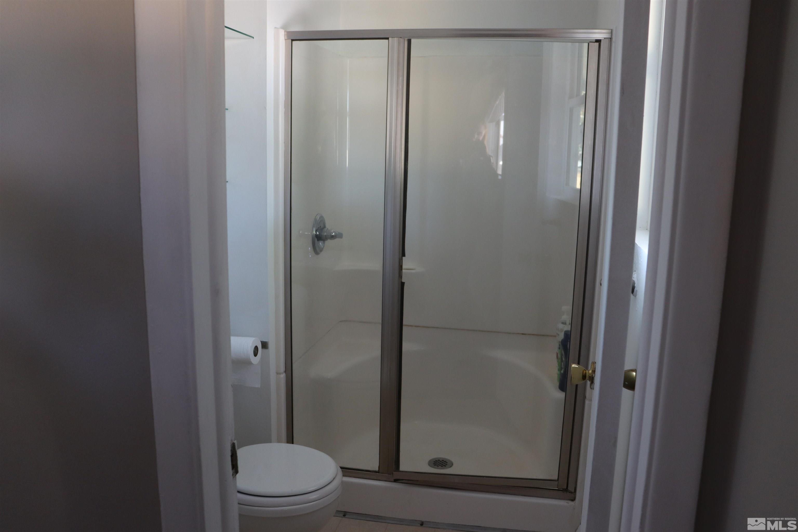 2650 Apollo Way Reno, NV 89503 - Photo 18 of 36 a bathroom with a glass shower door