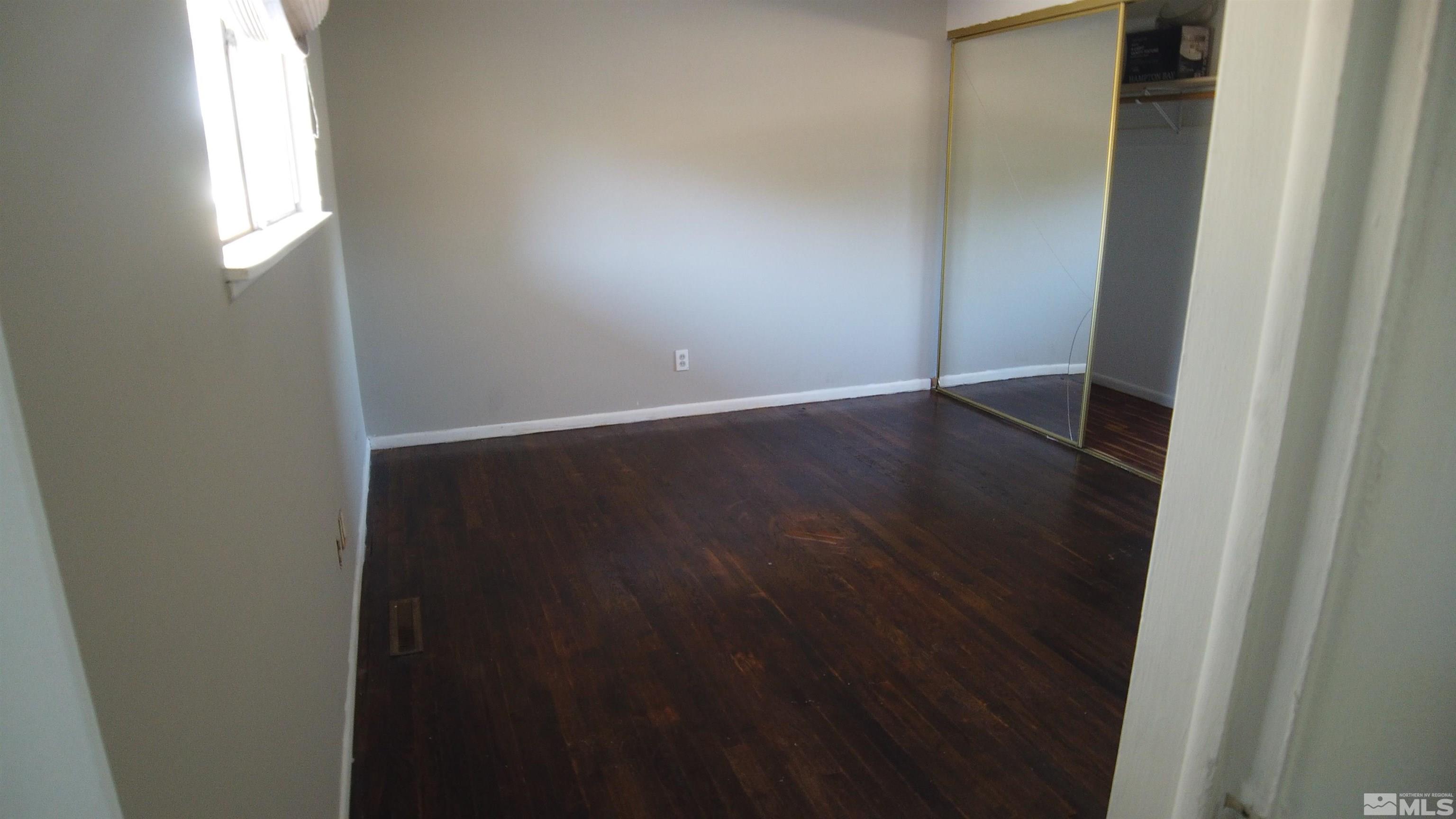 2650 Apollo Way Reno, NV 89503 - Photo 22 of 36 an empty room with wooden floor and windows