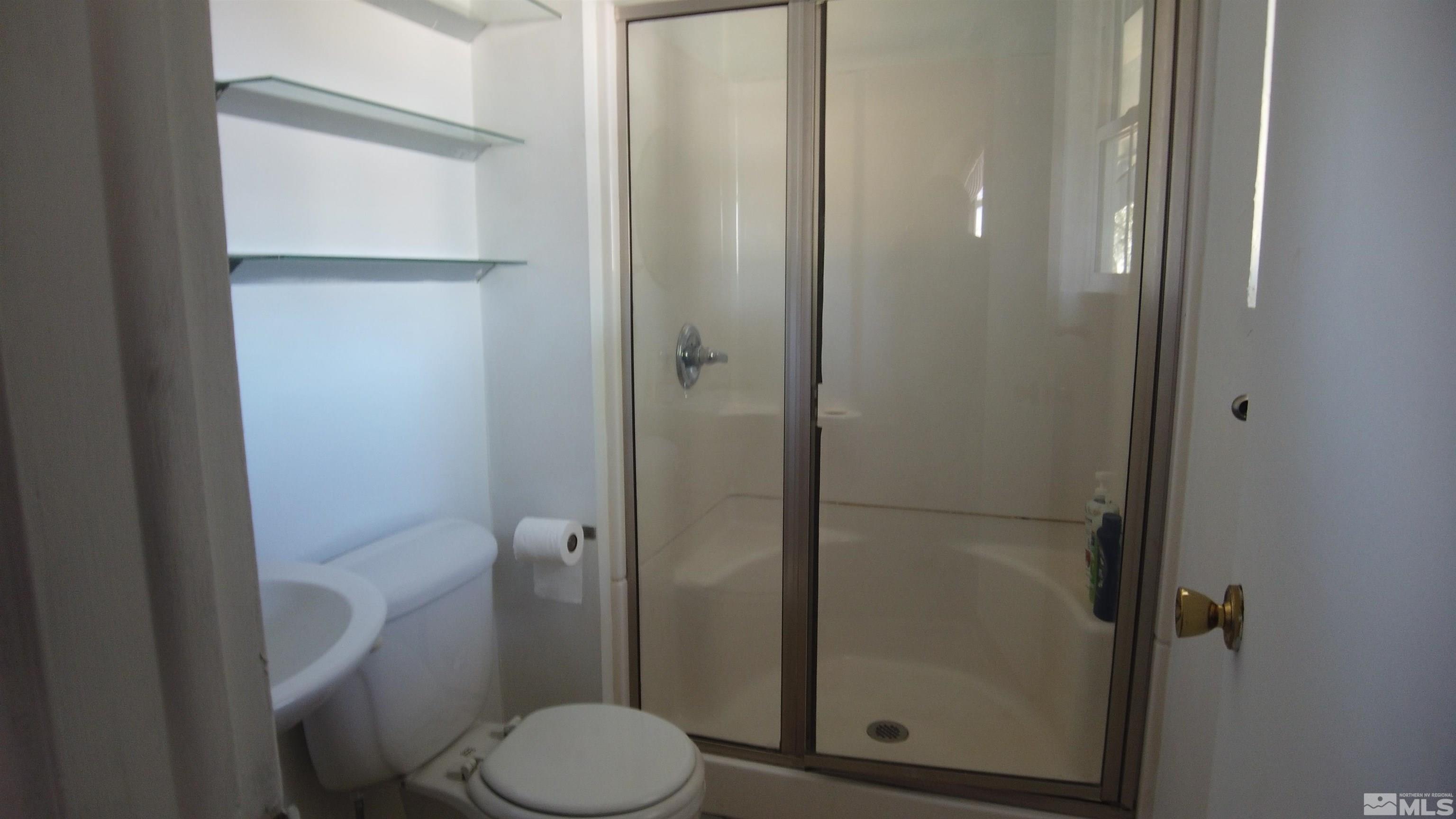 2650 Apollo Way Reno, NV 89503 - Photo 23 of 36 a bathroom with a toilet and a shower