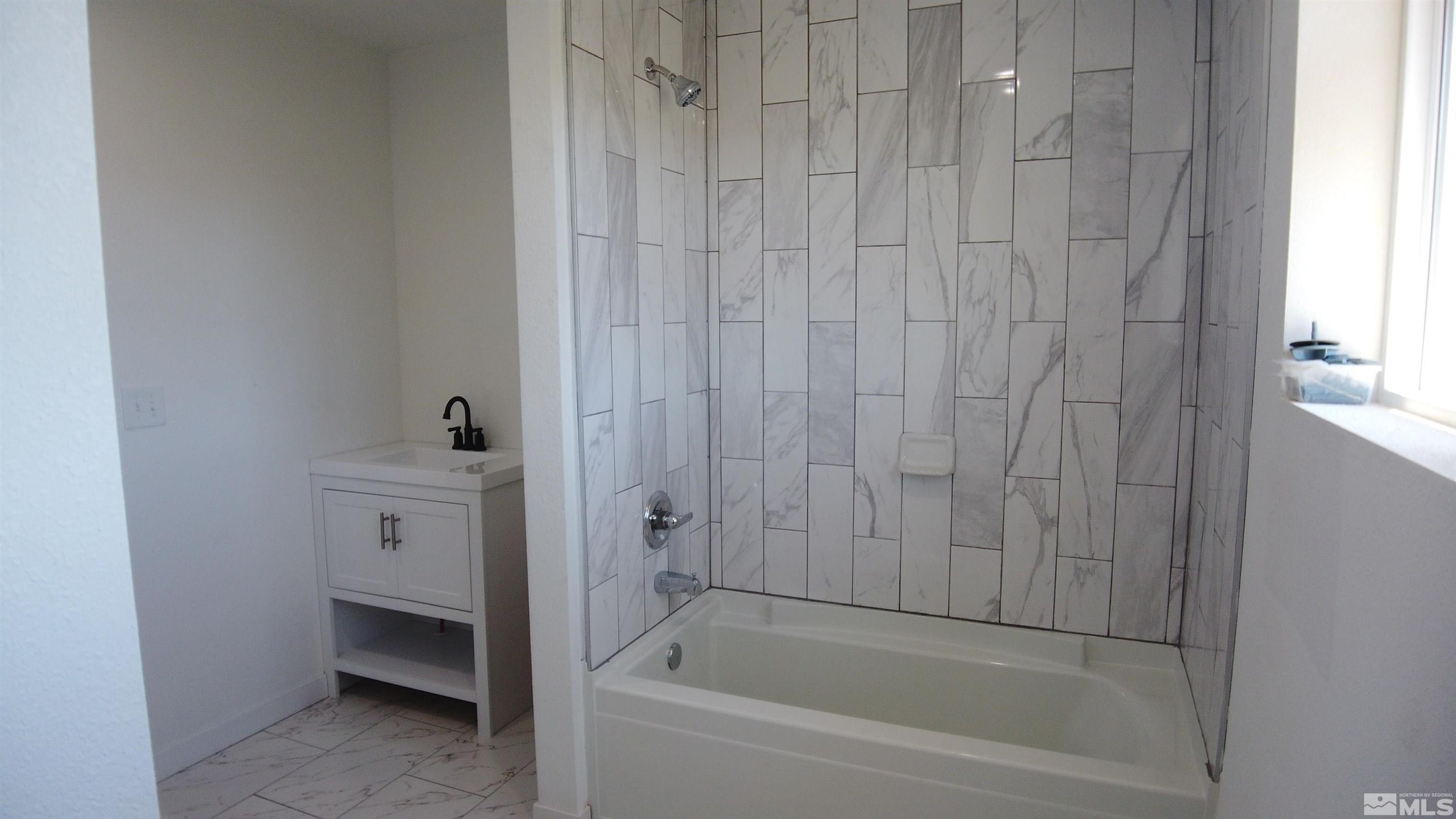 2650 Apollo Way Reno, NV 89503 - Photo 29 of 36 a bathroom with a bathtub and sink