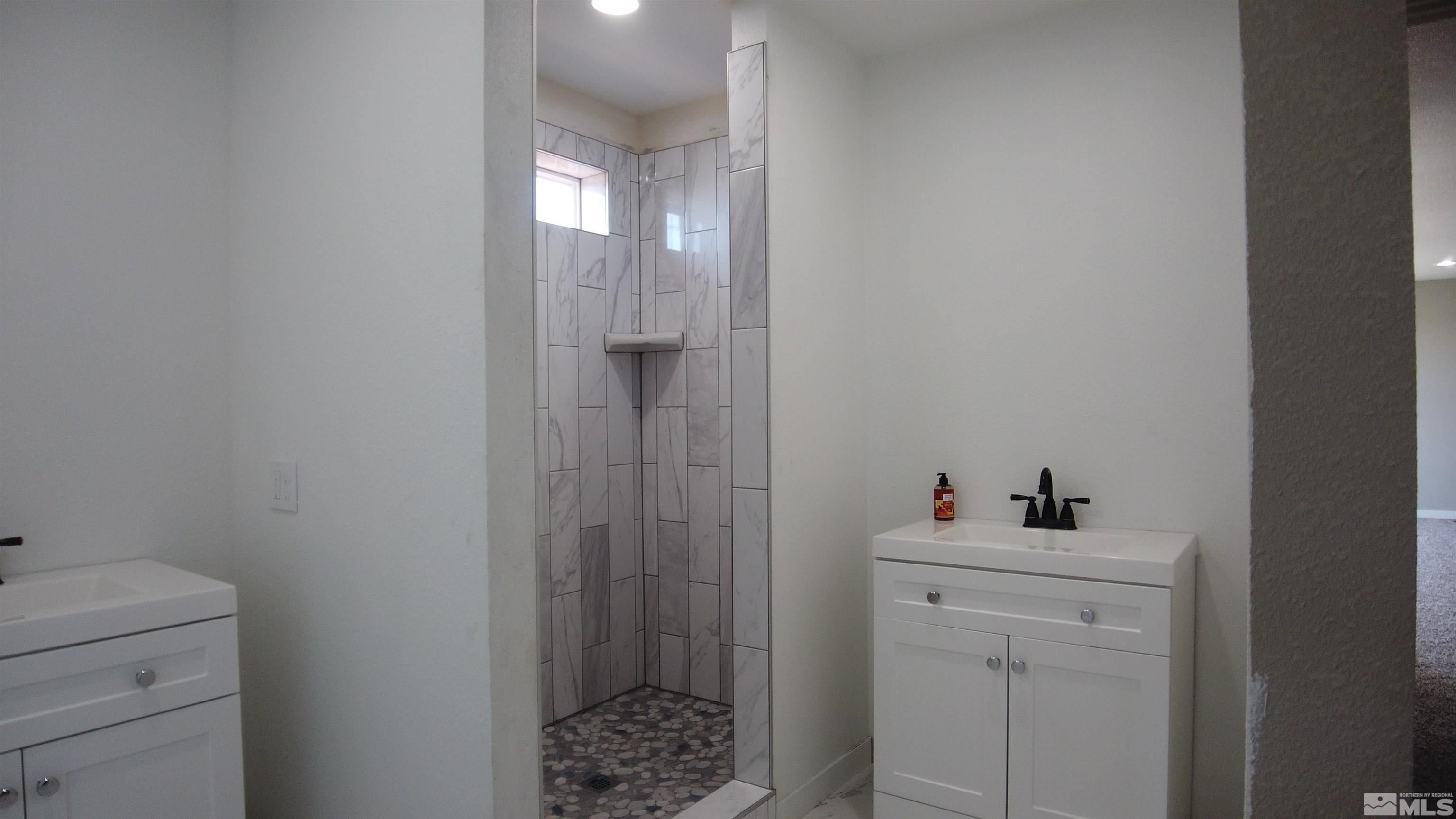 2650 Apollo Way Reno, NV 89503 - Photo 33 of 36 a bathroom with a sink toilet and shower