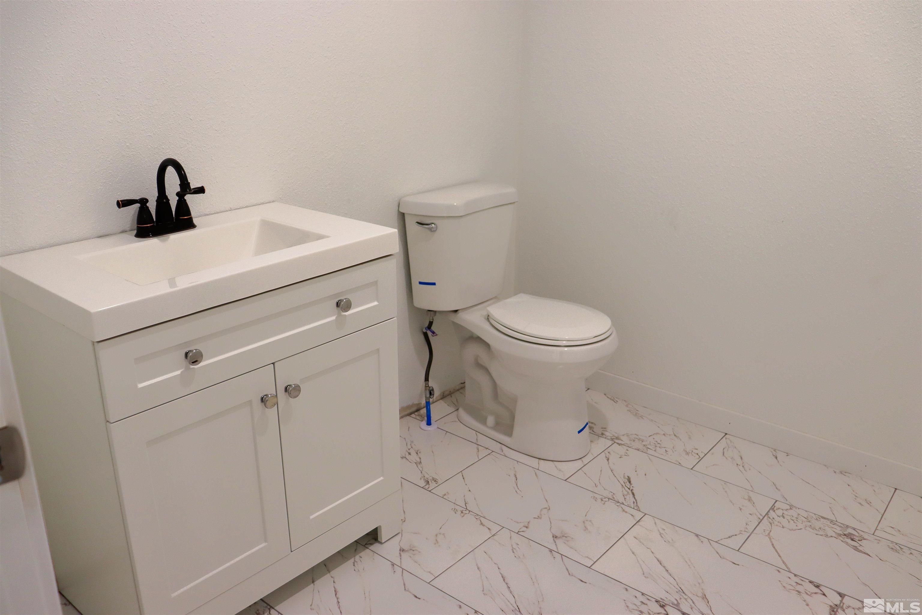 2650 Apollo Way Reno, NV 89503 - Photo 35 of 36 a bathroom with a toilet sink and mirror