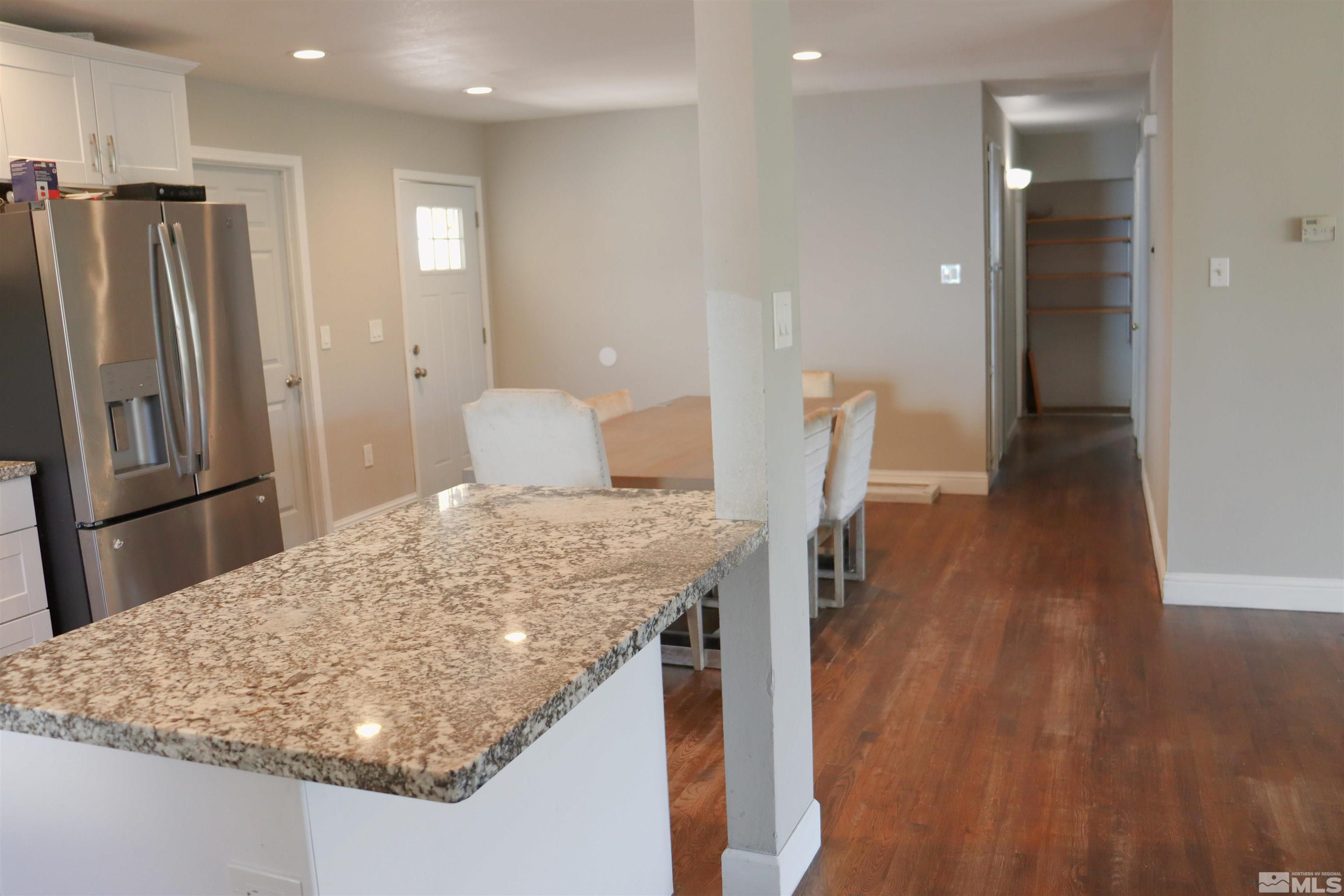 2650 Apollo Way Reno, NV 89503 - Photo 36 of 36 a kitchen with kitchen island sink refrigerator and stove