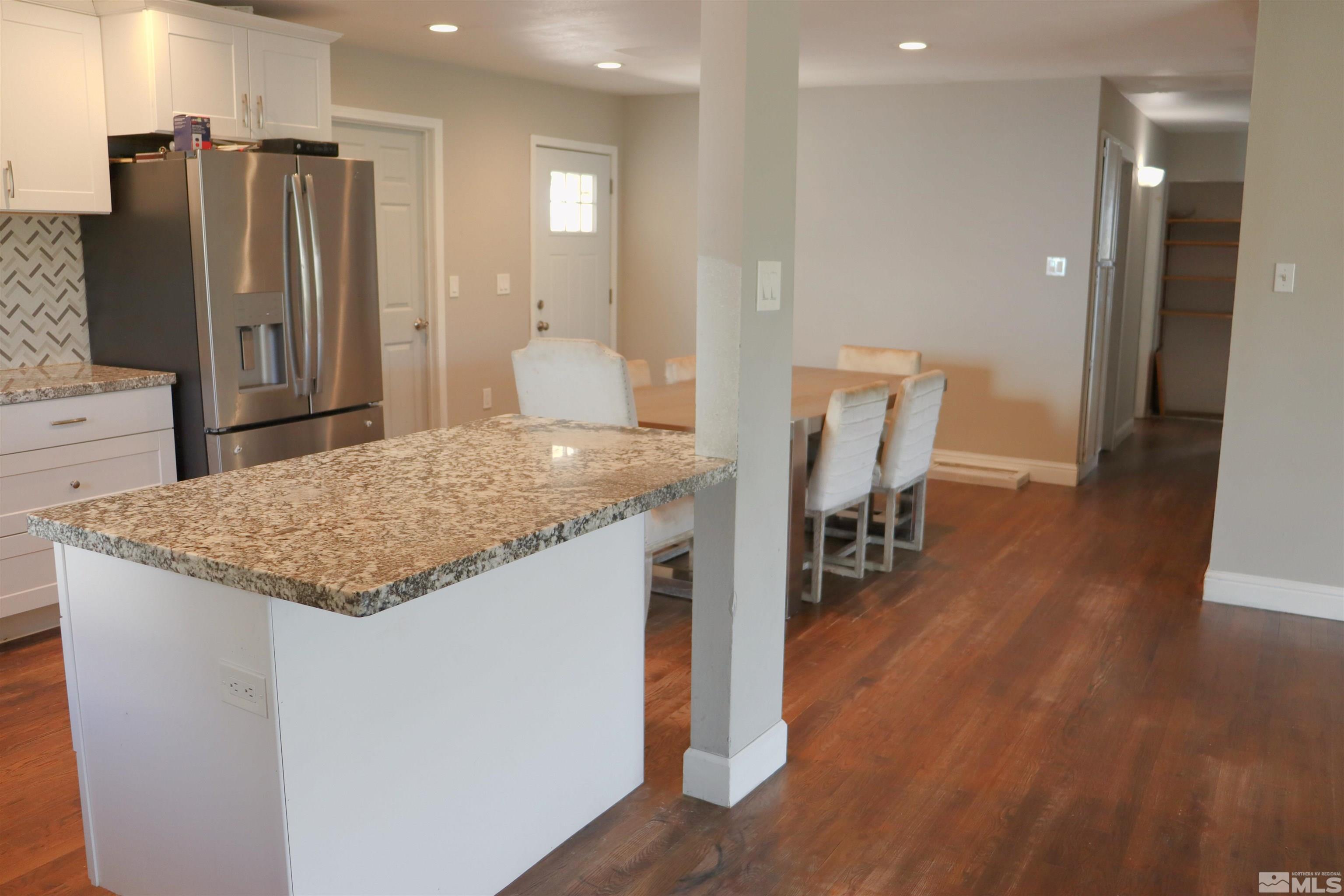 2650 Apollo Way Reno, NV 89503 - Photo 8 of 36 a kitchen with stainless steel appliances granite countertop a refrigerator and a stove top oven