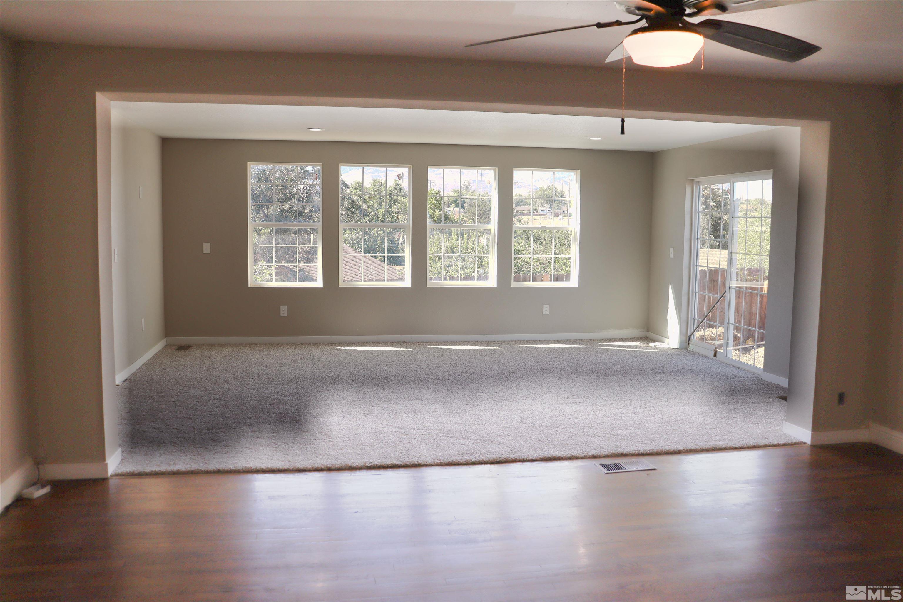 2650 Apollo Way Reno, NV 89503 - Photo 10 of 36 an empty room with wooden floor and windows