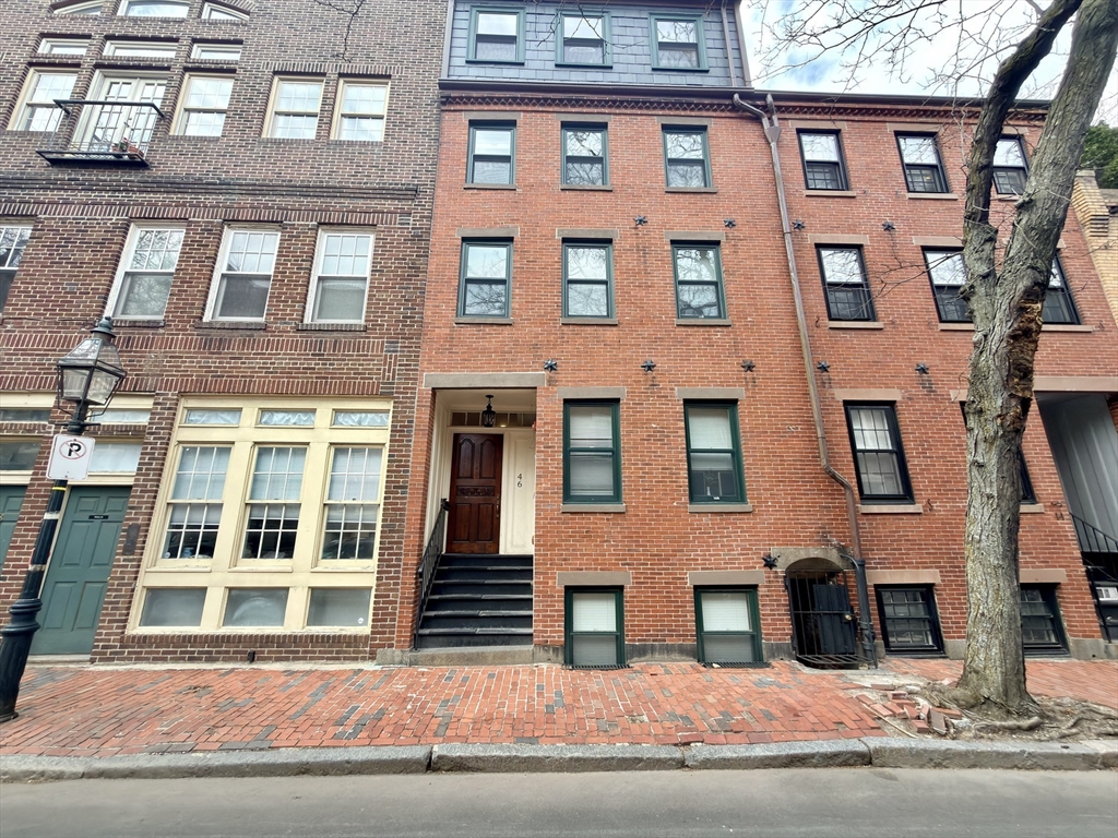 a view of a brick building next to a yard