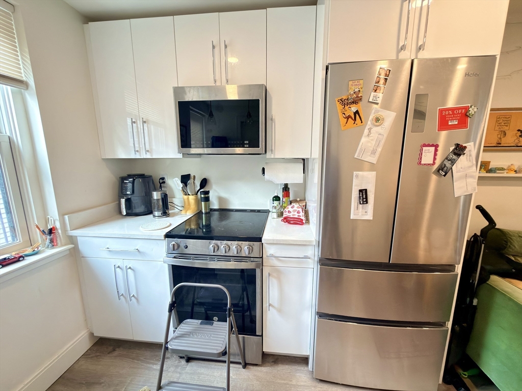 46 Melrose Street, Unit 3 Boston, MA 02116 - Photo 6 of 20 a kitchen with stainless steel appliances a refrigerator a microwave and cabinets