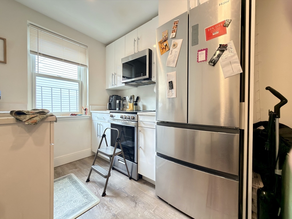46 Melrose Street, Unit 3 Boston, MA 02116 - Photo 7 of 20 a kitchen with stainless steel appliances granite countertop a refrigerator and a stove top oven