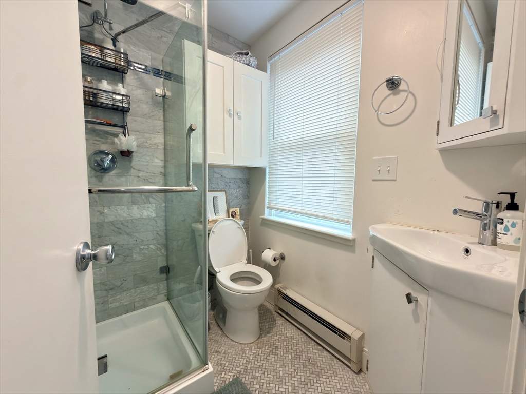 46 Melrose Street, Unit 3 Boston, MA 02116 - Photo 9 of 20 a bathroom with a granite countertop sink a toilet and shower