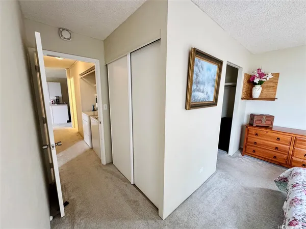 a view of a hallway and a livingroom with furniture