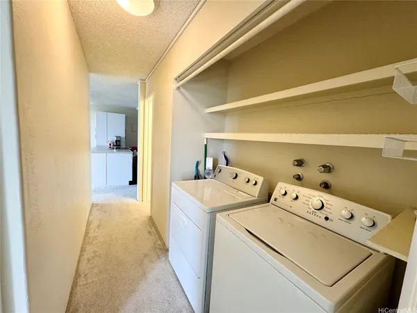 a view of a hallway with couch and a livingroom view
