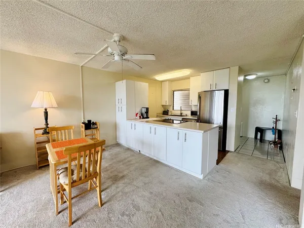 a large kitchen with a table and chairs