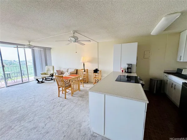 a living room with furniture a window and a table