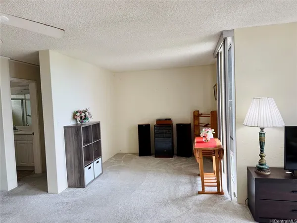 a bed room with a bed and a television