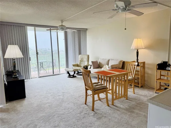 a dining room with furniture and a window