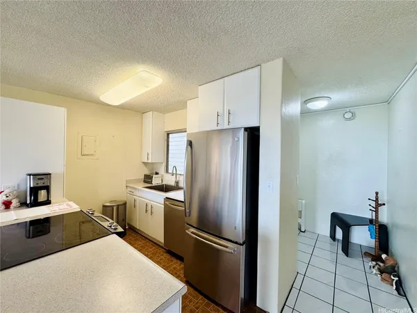 a kitchen with stainless steel appliances a refrigerator and a stove top oven