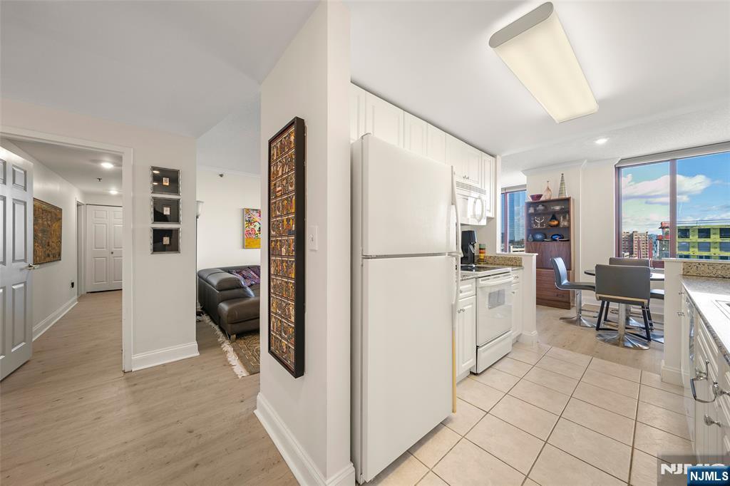 100 Old Palisade Road, Unit 2311 Fort Lee, NJ 07024 - Photo 12 of 25 a kitchen with a refrigerator and a stove top oven