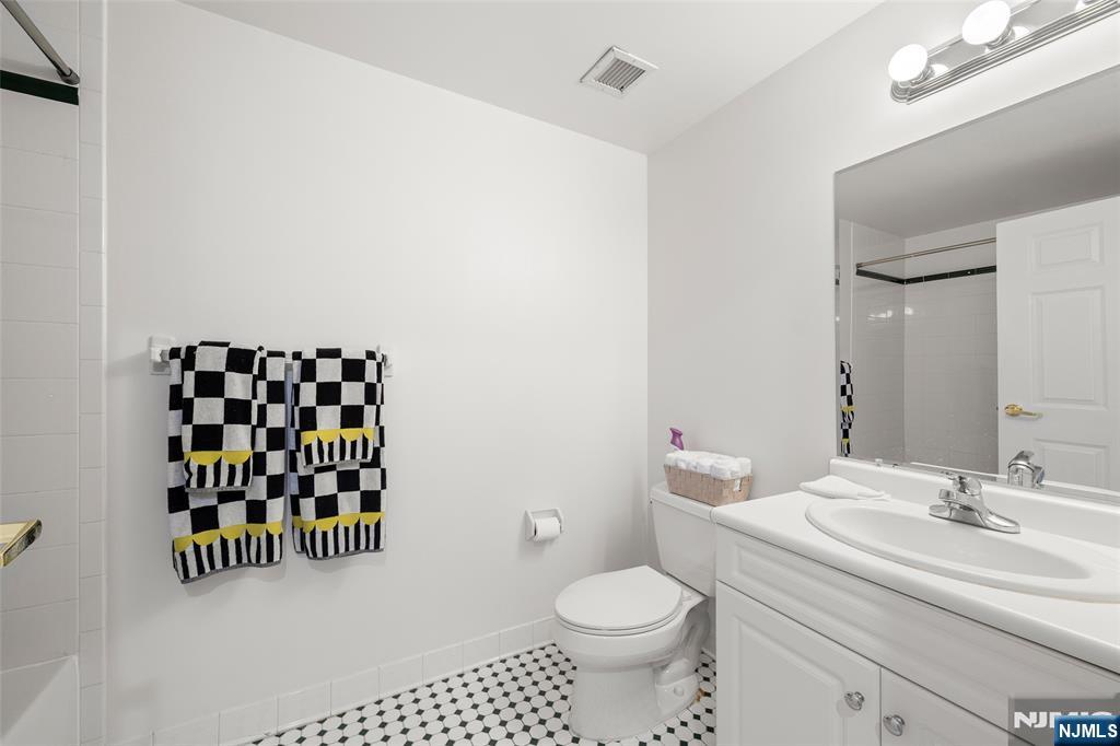 100 Old Palisade Road, Unit 2311 Fort Lee, NJ 07024 - Photo 19 of 25 a bathroom with a sink a toilet and a mirror