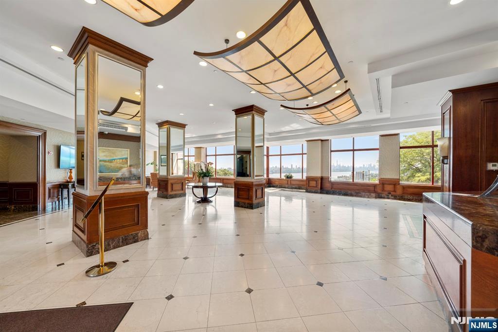 100 Old Palisade Road, Unit 2311 Fort Lee, NJ 07024 - Photo 2 of 25 a lobby with furniture and a large window