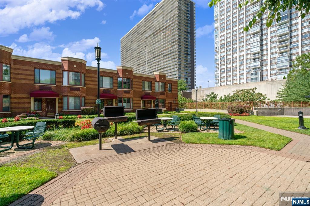 100 Old Palisade Road, Unit 2311 Fort Lee, NJ 07024 - Photo 23 of 25 a front view of a building with garden and trees