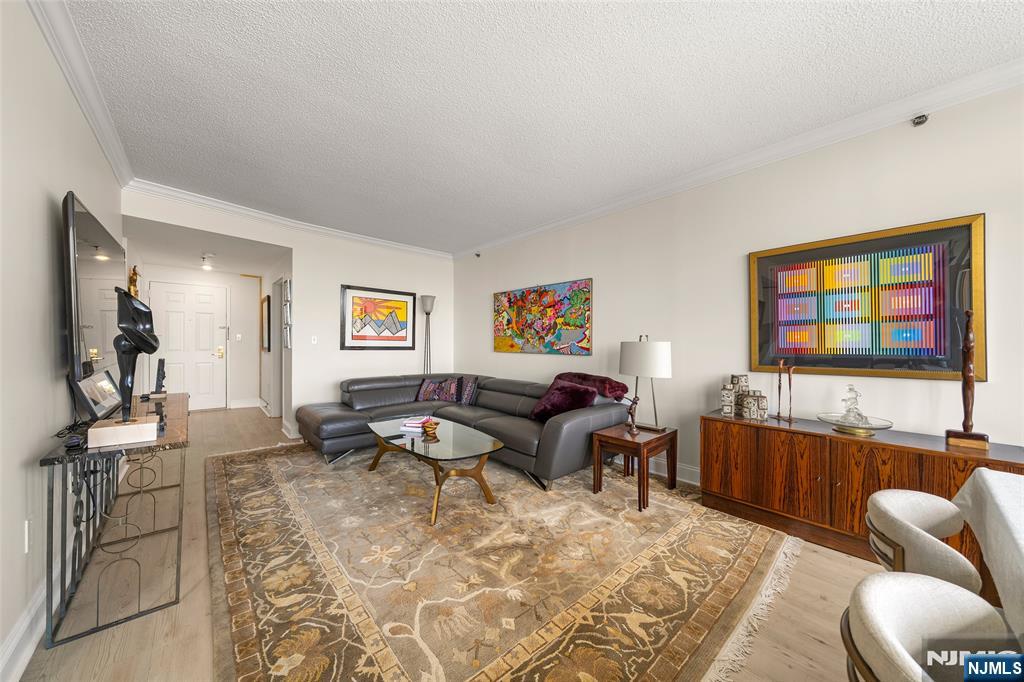 100 Old Palisade Road, Unit 2311 Fort Lee, NJ 07024 - Photo 6 of 25 a living room with furniture and a flat screen tv