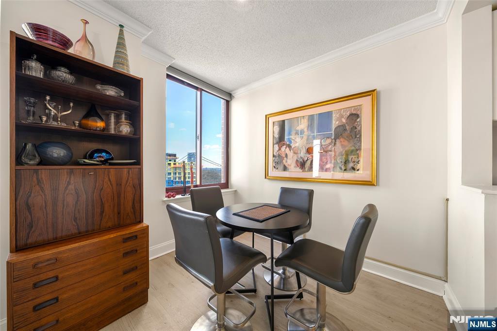 100 Old Palisade Road, Unit 2311 Fort Lee, NJ 07024 - Photo 8 of 25 a view of a dining room with furniture and closet